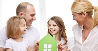 smiling parents and two little girls at new home