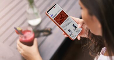 Upper angle shot young tanned woman holding smartphone sit outdo