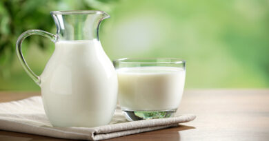 Fresh,Milk,On,Wooden,Table,Against,Blurred,Background,,Space,For