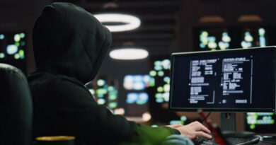 Hooded hacker breaking data servers at night closeup. Masked man pointing finger