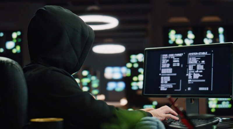 Hooded hacker breaking data servers at night closeup. Masked man pointing finger